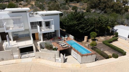 an aerial view of a house with a swimming pool at Wealthystays Niceday Hill Villa in Protaras