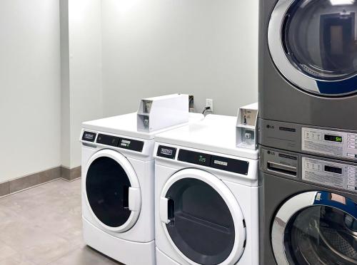 two washing machines and a washer and dryer in a room at Studio 6 Richmond-Airport in Sandston
