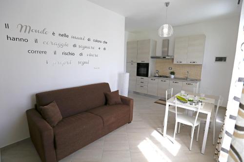 a living room with a couch and a table at Le Zagare in Lascari