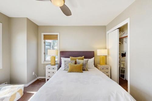 a bedroom with a large white bed with yellow pillows at Mountain Jewel in Crested Butte