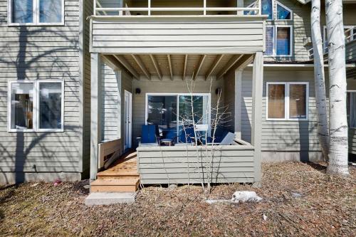 a house with a porch with blue chairs on it at Mountain Jewel in Crested Butte