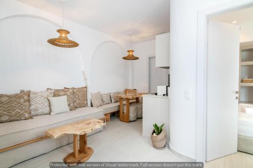a living room with a couch and a table at Joyful Tinos in Tinos Town