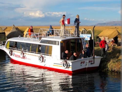 a boat with people on it on the water at Vista Alegre in Puno