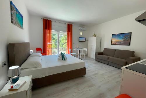 a bedroom with a bed and a living room at Rest House The Village in Nardò