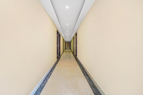 a corridor in a white building with a ceiling at Collection O 29 Church's Inn Near Cubbon Park in Bengaluru