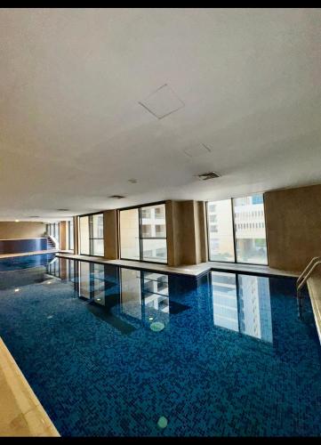a large swimming pool in a large building at Amman studio Damac Tower in Amman