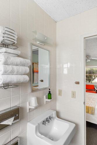 a white bathroom with a sink and a mirror at Motel Bear Lake in Bear Lake