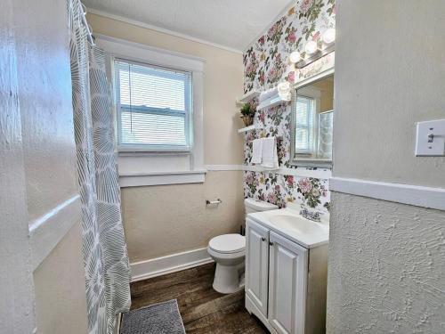 a bathroom with a toilet and a sink and a mirror at Charming house in Memphis in Memphis