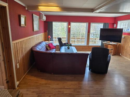 a living room with a couch and a television at Rent your own home in Velfjord in Saus