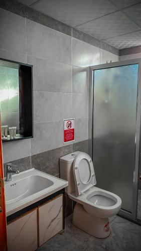 a bathroom with a toilet and a sink at Rum Angel Camp in Wadi Rum