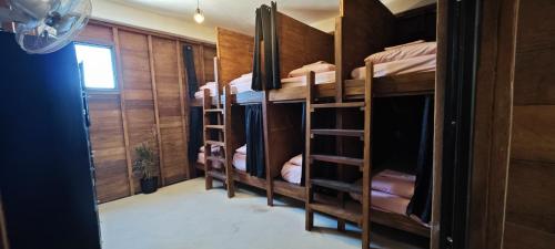a room with four bunk beds in a room at Casa Universo Holbox in Holbox Island