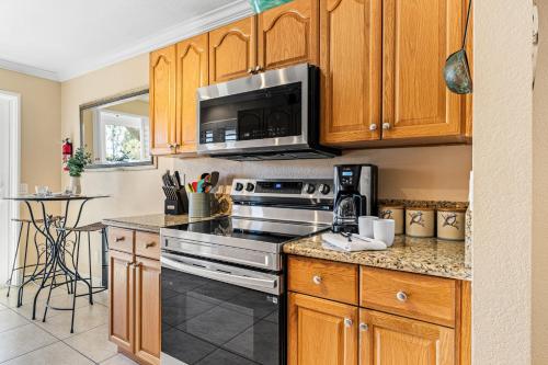 a kitchen with a stove and a microwave at Close to Beach w Patio Resort Amenities The Point at Corniche by AvantStay in Dana Point