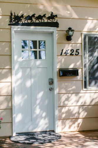 a white door with horse decals on a house at A Wilderness Retreat - Your Gateway to Yellowstone in Cody