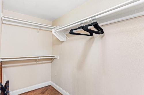 a walk in closet with a black hanger at Close to Beach w Patio Resort Amenities The Point at Corniche by AvantStay in Dana Point