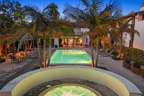 a pool at a hotel with palm trees around it at Close to Beach w Patio Resort Amenities The Point at Corniche by AvantStay in Dana Point