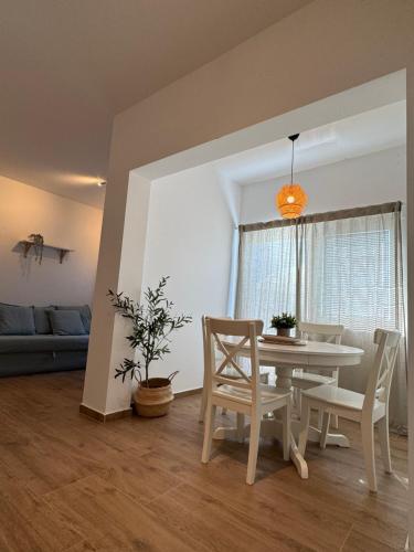 a living room with a table and chairs and a couch at Apartmant SEASIDE - great location, 2 min from beach, sunny terrace in Kukljica