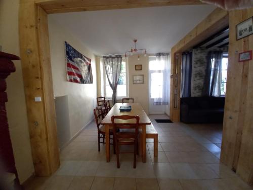 a kitchen and dining room with a table and chairs at Maison de Famille face à l'église in Sainte-Mère-Église