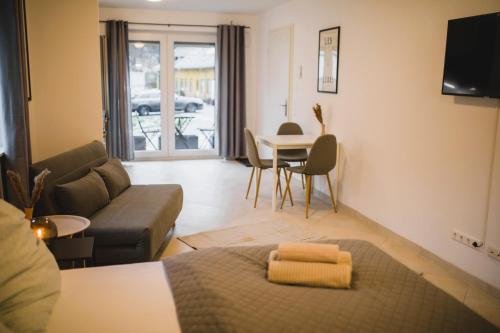 a living room with a couch and a table at HUGOS Design House am Waldrand - ruhig & modern in Bensheim