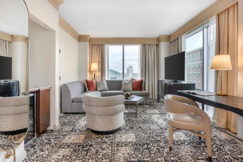 a living room with a couch and a table at Omni Severin Hotel in Indianapolis