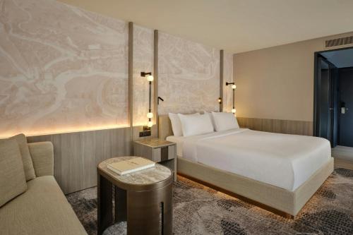 a hotel room with a bed and a couch at Ghent Marriott Hotel in Ghent