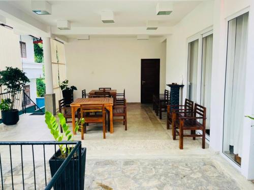 a dining room with wooden tables and chairs at Villa Lavish in Kandy