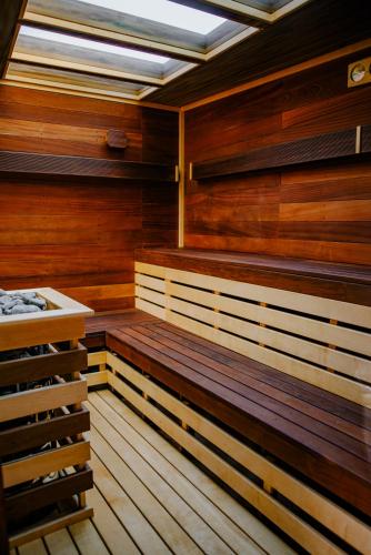 a sauna with wooden benches and a skylight at Cossara luxury villas - Adults Only in Balchik