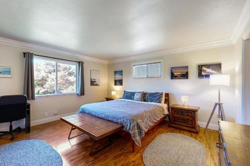 a bedroom with a bed and a table and a window at Park View in Fort Bragg