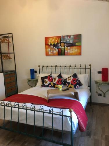 a bedroom with a bed with a painting on the wall at casa vacanza serena in Palazzago