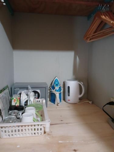 a kitchen counter with a sink and a microwave at Ultimate Freedom Bed and Breakfast in Santa Cruz