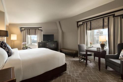 a hotel room with a large bed and a desk at Fairmont Hotel Macdonald in Edmonton