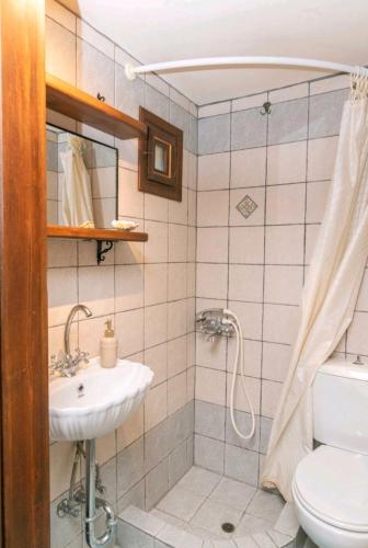 a bathroom with a sink and a toilet at Πέτρινο in Tinos
