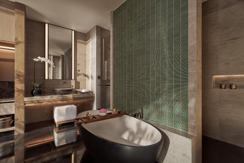 a bathroom with a bath tub and a shower at Regent Phu Quoc in Phu Quoc