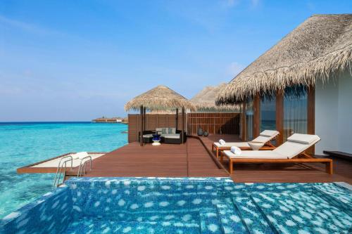 a resort with a swimming pool in the ocean at W Maldives in Fesdu Island