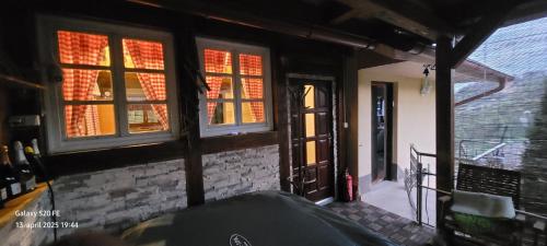 a room with two windows and a brick wall at Farm ,zidanica ,JOLI in Gorica pri Slivnici