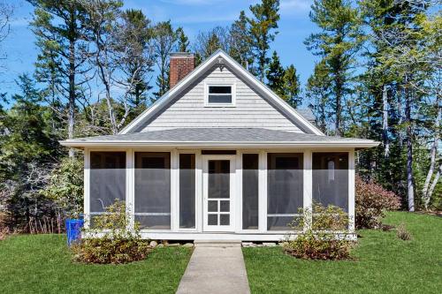 a small house with a screened in porch at Pine Ledge in Boothbay Harbor