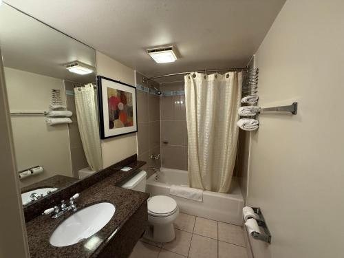 a bathroom with a sink and a toilet and a shower at Fiesta Inn Los Angeles - Bell Gardens in Bell Gardens
