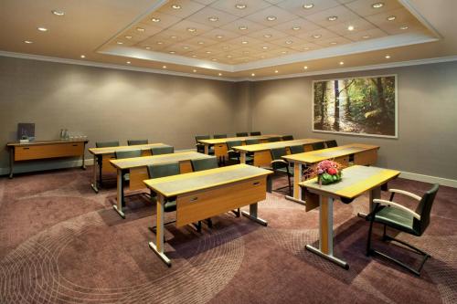 a classroom with tables and chairs in a room at Sheraton Grand Warsaw in Warsaw