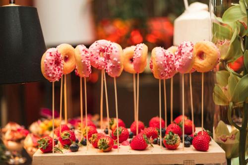 a bunch of donuts and strawberries on a stick at Sheraton Grand Warsaw in Warsaw