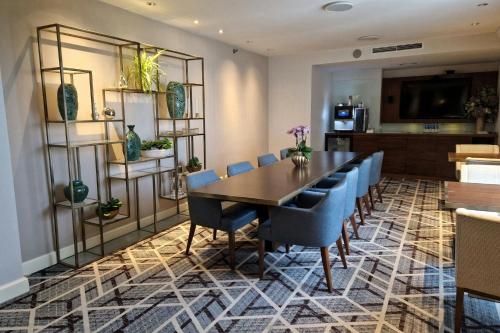 a dining room with a table and blue chairs at Sheraton Grand Warsaw in Warsaw
