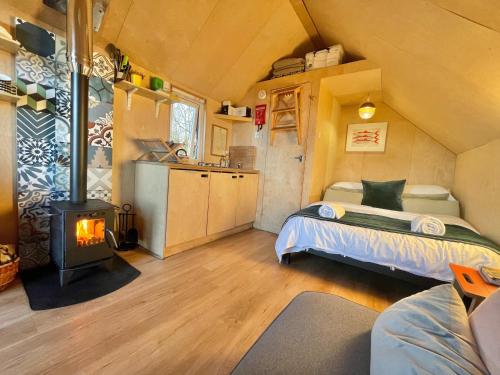 een slaapkamer met een bed en een fornuis in een kamer bij St Oswald Beach Hut Alnmouth in Alnmouth
