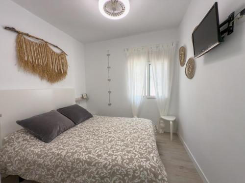 a bedroom with a bed and a television in it at Villa Tarifa in Torrox