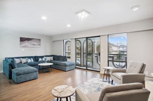 a living room with a couch and chairs and a table at 6 Bedroom Family Home with Indoor Arcade, BBQ, Huge Backyard & Pickleball in Vancouver