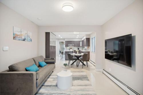 a living room with a couch and a table at 6 Bedroom Family Home with Indoor Arcade, BBQ, Huge Backyard & Pickleball in Vancouver