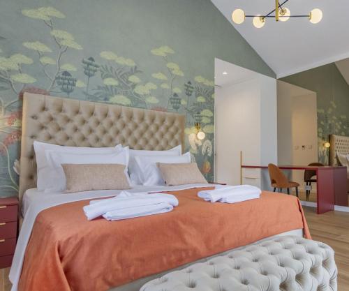 a bedroom with a large bed with towels on it at Villa Decima near Split - Heated Pool, Tennis Court & Billiards in Dicmo