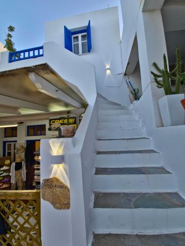 a staircase in a white building with a potted plant at Trouhalos Apartment in Livadion