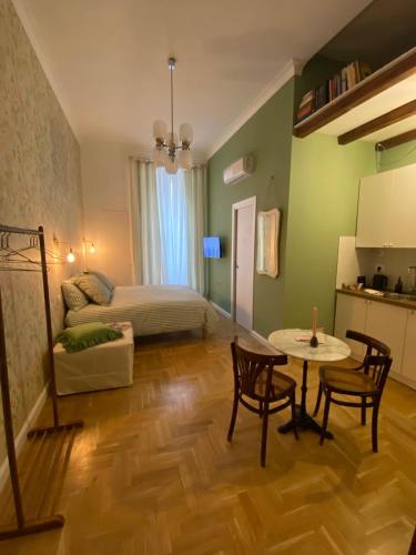 a bedroom with a bed and a table and chairs at Casa Margherita in Naples