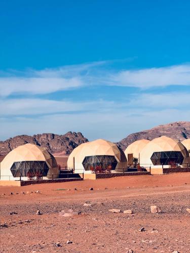a row of domes in the middle of a desert at Rum Angel Camp in Wadi Rum