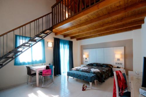 a bedroom with a large bed and a staircase at Theros Hotel in Tavronitis