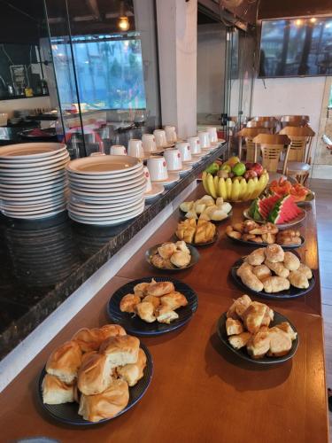 a buffet line with many different types of food on plates at Samba Angra dos Reis in Angra dos Reis