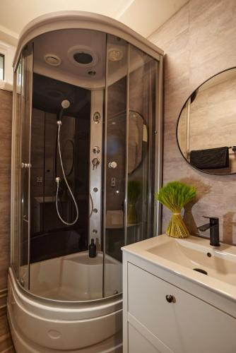 a bathroom with a shower and a sink at ArtSuite in Košice